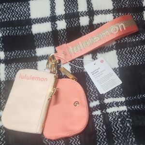 lululemon dual pouch wristlet in light pink and coral with gold strap